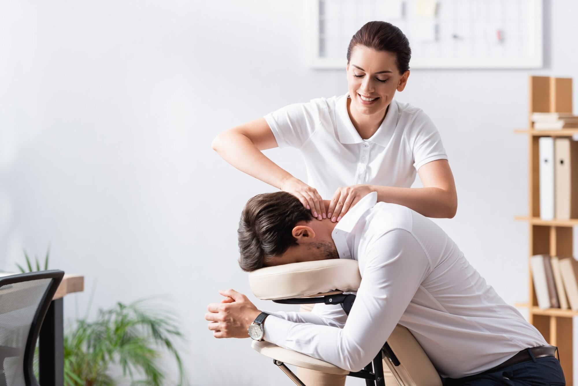A massage therapist consulting with a client about their needs.